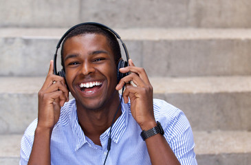 Happy african american man laughing with headphones