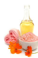 Spa and wellness setting with sea salt, oil essence, flowers