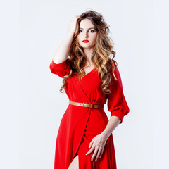 Woman in dress  lies on a red background