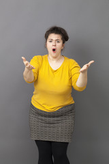 unhappy overweight young woman staring at someone with hands forward claiming and grumbling