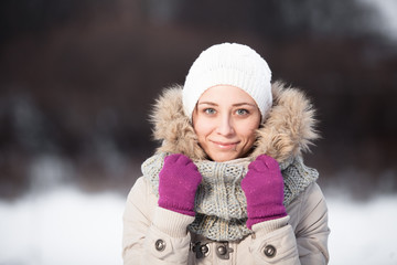 Smiling beautiful young woman relaxing outdoor in a winter day