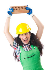 Female workman in green overalls holding brick isolated on white