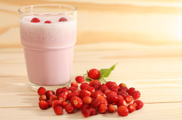 Smoothie from wild strawberries in a glass and wild  strawberries