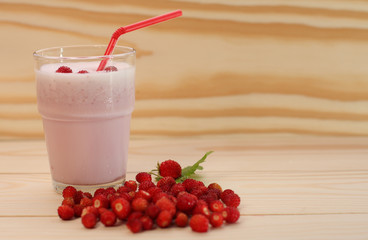 Smoothie from wild strawberries in a glass and wild  strawberries