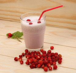 Smoothie from wild strawberries in a glass and wild  strawberries
