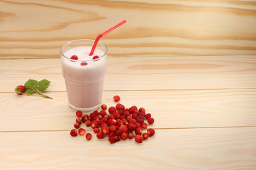 Smoothie from wild strawberries in a glass and wild  strawberries