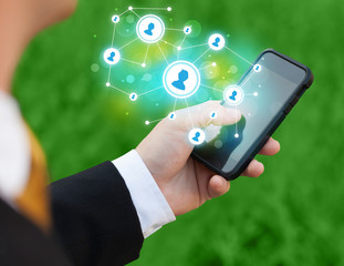 Finger pointing on smartphone, social network concept