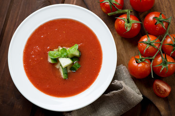 Gazpacho with cucumber and green basil topping, above view
