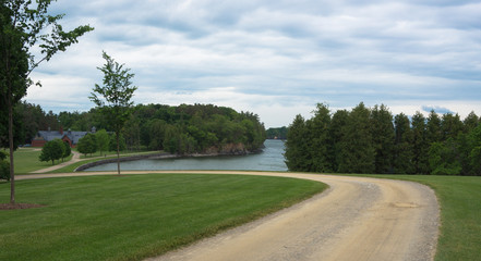 road curves around to the lake shore and the historic estate Coach Barn in a distance