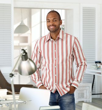 Happy young man smiling at home