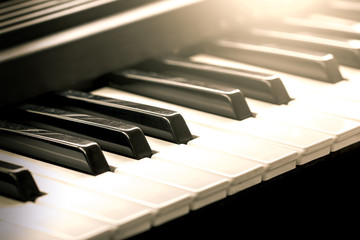 Naklejka premium Black and white piano keys in vintage color tone,music concept