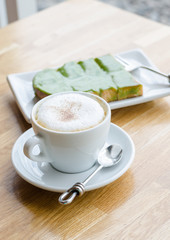 Hot coffee and bread on wood table