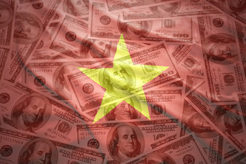 colorful waving vietnamese flag on a american dollar money background