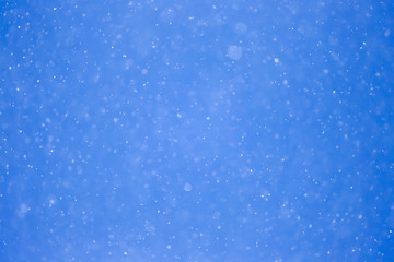 snowing on a blue sky