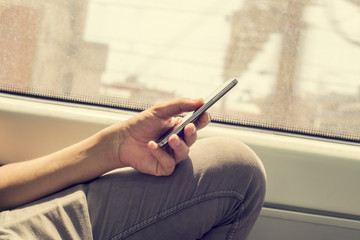 young man using a smartphone in a train or a subway