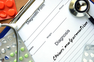 Diagnostic form with diagnosis Chiari malformation and pills.