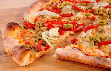 Italian vegetarian pizza on wooden surface