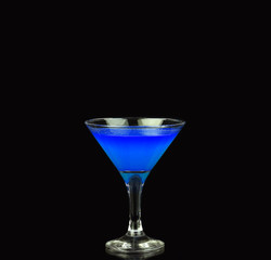 Blue alcoholic cocktail on the black background