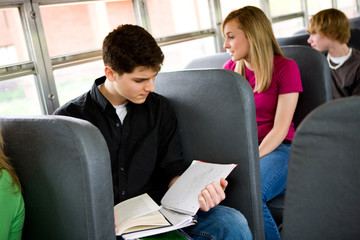 School Bus: Boy Doing Schoolwork on Bus