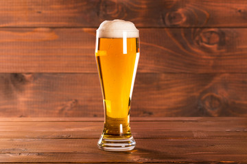 Glass beer on wood background