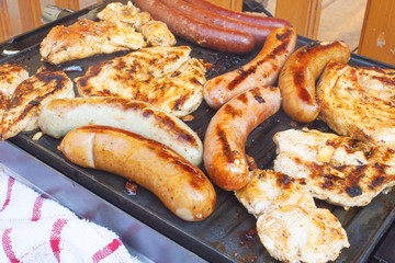 Barbecue on the electric grill.  Summer party, detailed view of grilled chicken and sausage.
