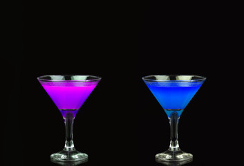 Cosmopolitan cocktail in a nice purple and blue in front of a black background