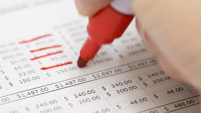 Man checking household budget numbers - money saving concept