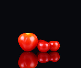 fresh tomatoes on a black background