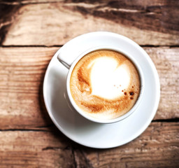 Cup of Coffee for breakfast on rustic wooden table, top view. Ca