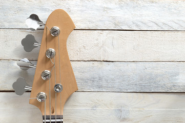 Electric Bass Guitar, against a white wooden background. Editor's view. Wide copy space for...