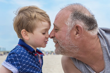 grandfather and grandson on the beach