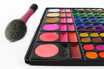 Palette of colorful eye shadows and makeup brush