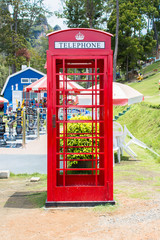 red telephone box in garden of 7 heaven krabi thailand