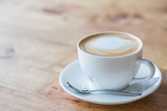Coffee in white cup on wood table