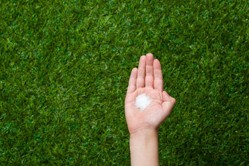 Human hand holding crystal sugar 