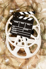 Cinema movie reel and clapper board 35 mm film background