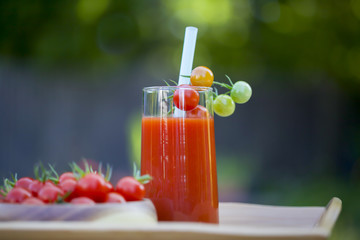 Cherry tomatoes and a glass of tomato juice.