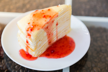 Crepe cake with strawberry sauce
