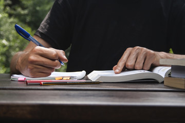 young man studing and taking notes