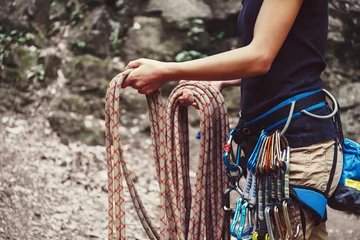 Printed kitchen splashbacks Mountaineering Woman holding climbing rope near the rock