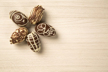 Chocolate Easter Eggs Over Wooden Background