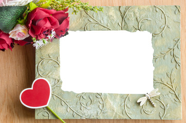 Blank photo frame and red rose.