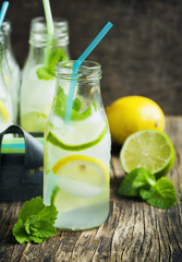 Lemonade in glass bottle with ice and mint