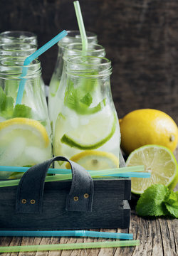 Lemonade in glass bottle with ice and mint