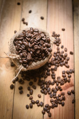 coffee bean in sack on wood background
