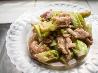 fried vegetable with pork sauce on plate