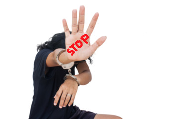 blurry women hand in handcuff show hand symbol stop ,Slave-Human Trafficking concept