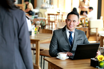 businessman looking at his client coming for meeting