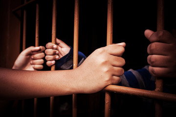 vintage of asian boy Hand in jail