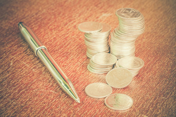 Pen and coins with filter effect retro vintage style
